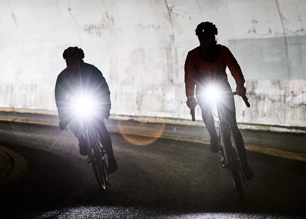 can bike lights be too bright - two cyclists in tunnel with very bright bike lights